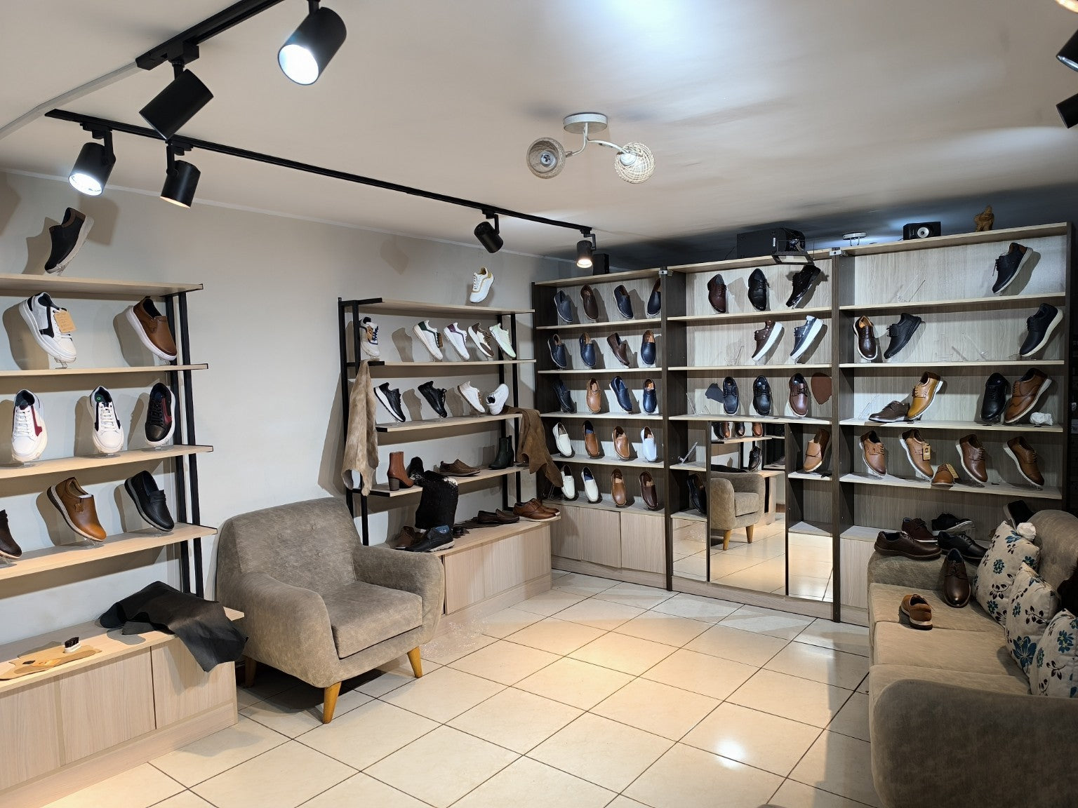Showroom de André Calzados en Los Olivos, con calzados de cuero, asientos y espejo para probarte